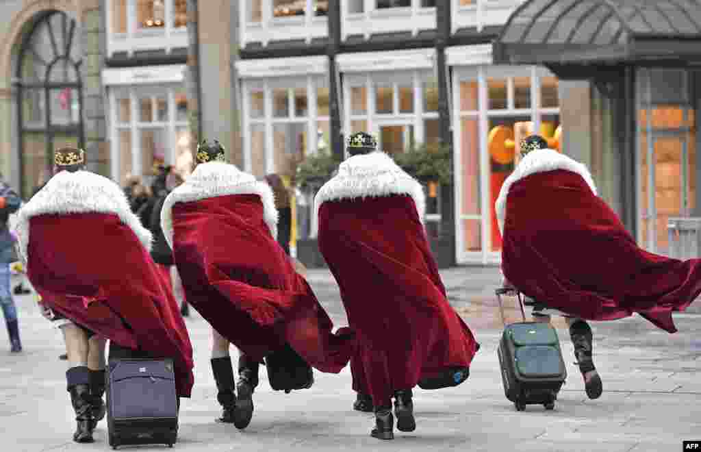 Four men dressed as kings arrive in the city center when tens of thousands revelers celebrate the start of the street-carnival in Cologne, Germany.