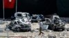 A man walks among the wreckage of vehicles as Turkish rescue workers and police inspect the blast scene following a car bomb attack on a police station in the eastern Turkish city of Elazig, Aug. 18, 2016. The explosion, blamed by Defense Minister Fikri Isik on the outlawed Kurdistan Workers' Party (PKK), happened in the garden of the four-storey building in Elazig.