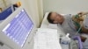 FILE - A stroke patient undergoes an electrocardiogram at Juntendo University Hospital in Tokyo. Scientists have found that a neurotoxin secreted by a deadly Australian spider contains a molecule that stalls the effects a stroke has on the brain.