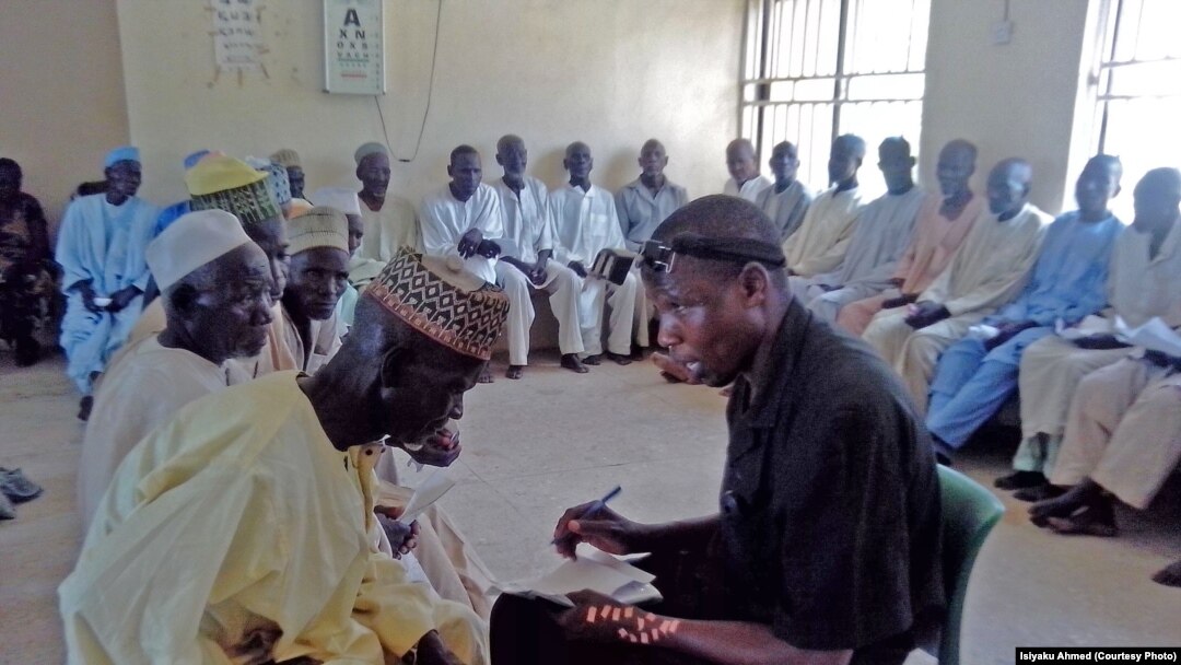 An optician interviews cataract patients at Gunduma Hospital System Council General Hospital, Dutse, before patients undergo surgery to prevent blindness.