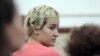Detained Tunisian member of the Ukrainian women’s group Femen, Amina Sboui, sits at the Msaken court, where she faces a new set of charges of insulting and defaming state employees, July, 22; 2013.