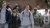 FILE - Students walk across campus at the University of Vermont in Burlington, Vermont.