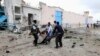 Somali government soldiers evacuate an injured man after a suicide bomb attack at a U.N. compound in Mogadishu, June 19, 2013. 