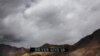 In this Sept. 14, 2017, file photo, a banner erected by the Indian army stands near Pangong Tso lake near the India-China border in India's Ladakh area.