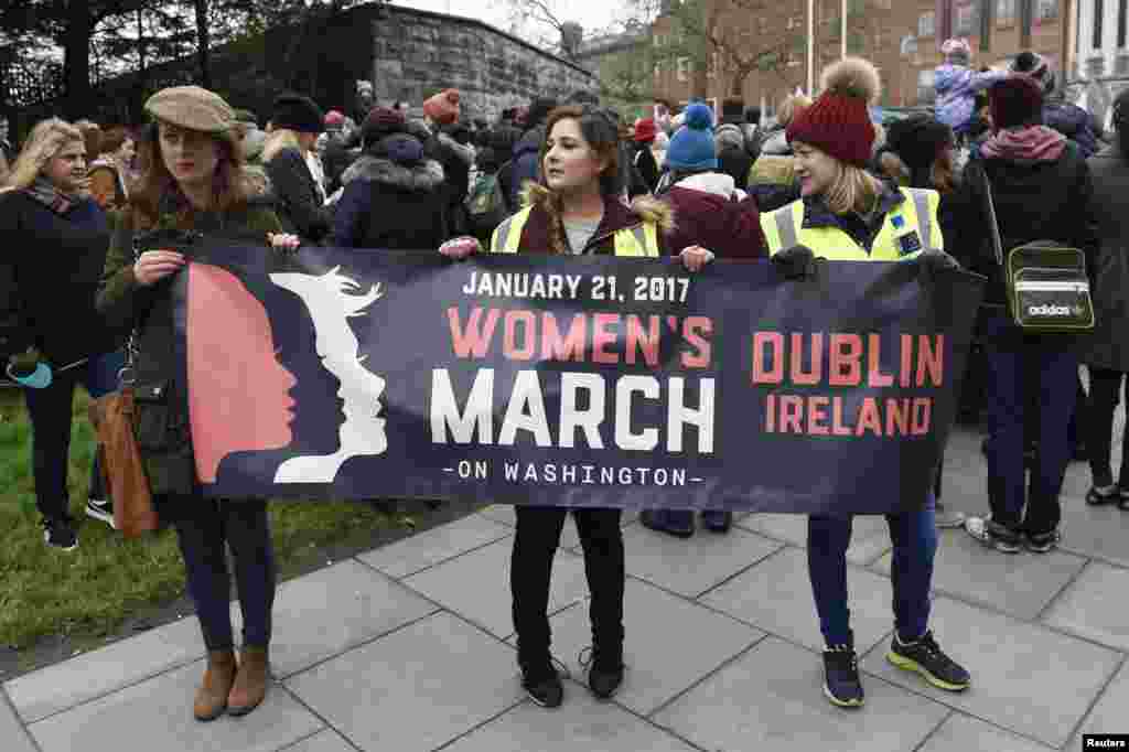Protesters pose for a photograph with a banner before they take part in the Women's March on Dublin, Ireland Jan. 21, 2017.