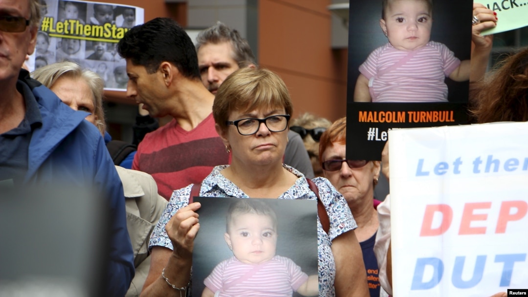 Activists hold placards and chant slogans as they protest outside the offices of the Australian Immigration Department in Sydney, Feb. 4, 2016. A public campaign on behalf of Baby Asah and her parents has prompted the immigration minister to allow the family to remain in the country instead of being sent back to a remote detention camp.