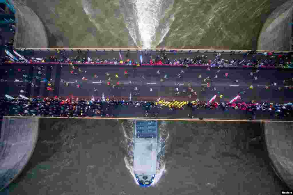 Runners cross the half way point on Tower Bridge during the London Marathon.
