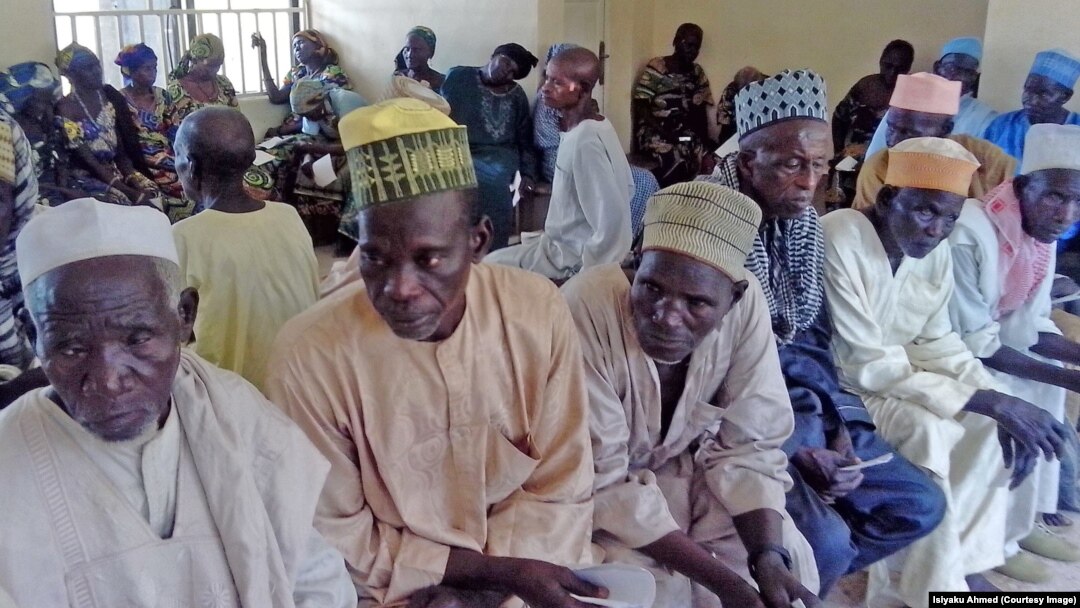 Men and women from Jigawa State wait for interviews to determine if they qualify for surgery to prevent blindness. 