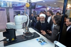 FILE - President Hassan Rouhani listens as he is being updated on Iran's nuclear achievements, in Tehran, Iran, April 9, 2018.