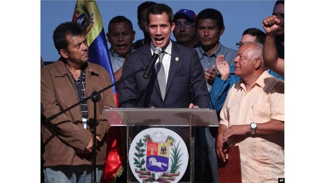 Venezuela's opposition leader and self proclaimed interim President Juan Guaido, center, speaks during a meeting with oil workers at the Metropolitan University of Caracas, Venezuela, May 3, 2019.