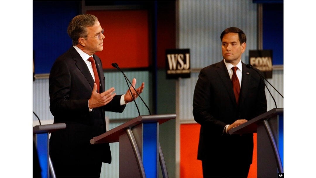 Jeb Bush, left, speaks as Marco Rubio listens during Republican presidential debate at Milwaukee Theatre, Tuesday, Nov. 10, 2015, in Milwaukee.