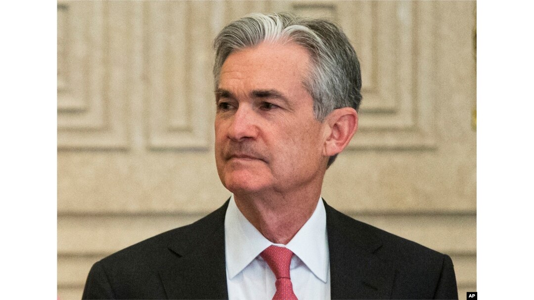 FILE - Federal Reserve Gov. Jerome Powell talks with others before a Board of Governors meeting in Washington, Nov. 30, 2015.