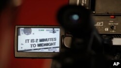 A member of the media films the Doomsday Clock after a news conference at the National Press Club in Washington, Jan. 25, 2018, announcing that the Bulletin of the Atomic Scientists has moved the minute hand of the Doomsday Clock to two minutes