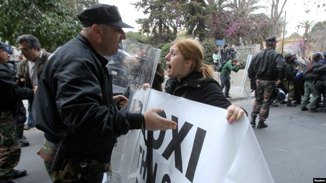 A protester tries to pass a police cordon during a rally by bank employees in Nicosia, Mar. 21, 2013.