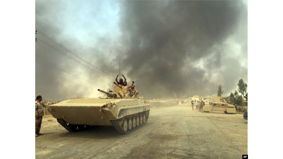 Iraqi Security Forces enter Qayara, 70 kilometers (45 miles) south of Mosul, after defeating Islamic State group forces in northern Iraq, Aug. 25, 2016.