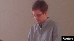 Russia -- Former intelligence agency contractor Edward Snowden speaks to human rights representatives at Moscow's Sheremetyevo airport, July 12, 2013