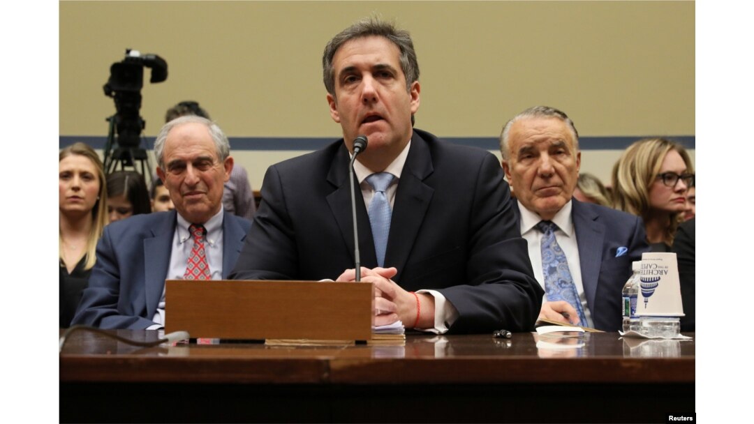 FILE - Michael Cohen, the former personal attorney of U.S. President Donald Trump, is flanked by his attorneys Lanny Davis, left, and Mike Monico as he testifies before a House oversight committee hearing on Capitol Hill in Washington, Feb. 27, 2019.