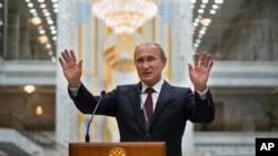 Russian President Vladimir Putin speaks to the media after his talks with Ukrainian President Petro Poroshenko in Minsk, Belarus, Aug. 27, 2014.