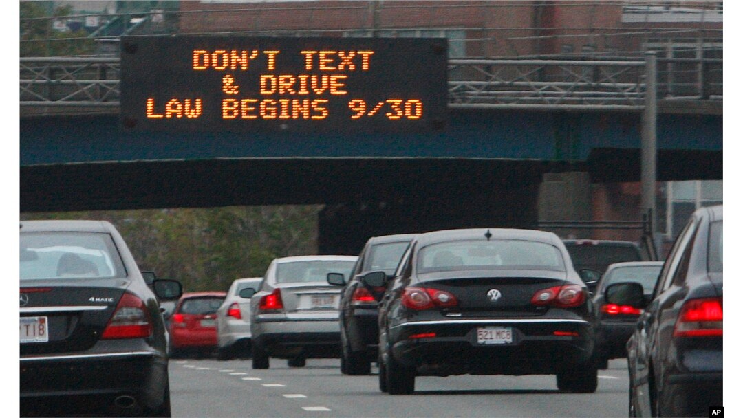 In this photo taken Friday, Sept. 24, 2010, a sign over the Massachusetts Turnpike in Boston alerts motorists to a new state law banning texting while driving. (AP Photo/Bill Sikes)