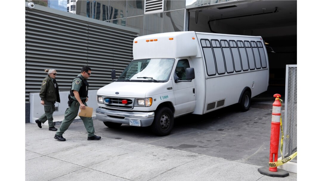 FILE - A vehicle carrying asylum-seekers brought from Tijuana, Mexico, to the United States for their immigration hearing arrives at a court in San Diego, California, March 19, 2019.