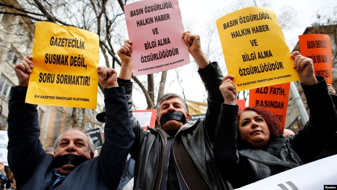 FILE - Journalists demanding greater media freedom are seen at a rally against Turkey's ruling AK Party.