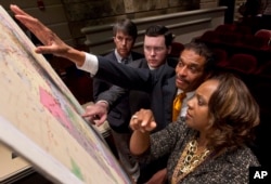 FILE - Lawmakers study a map of the proposed redistricting plan following a meeting of the Legislative Committee on Reapportionment at the Alabama Statehouse in Montgomery, Ala., May 9, 2012.