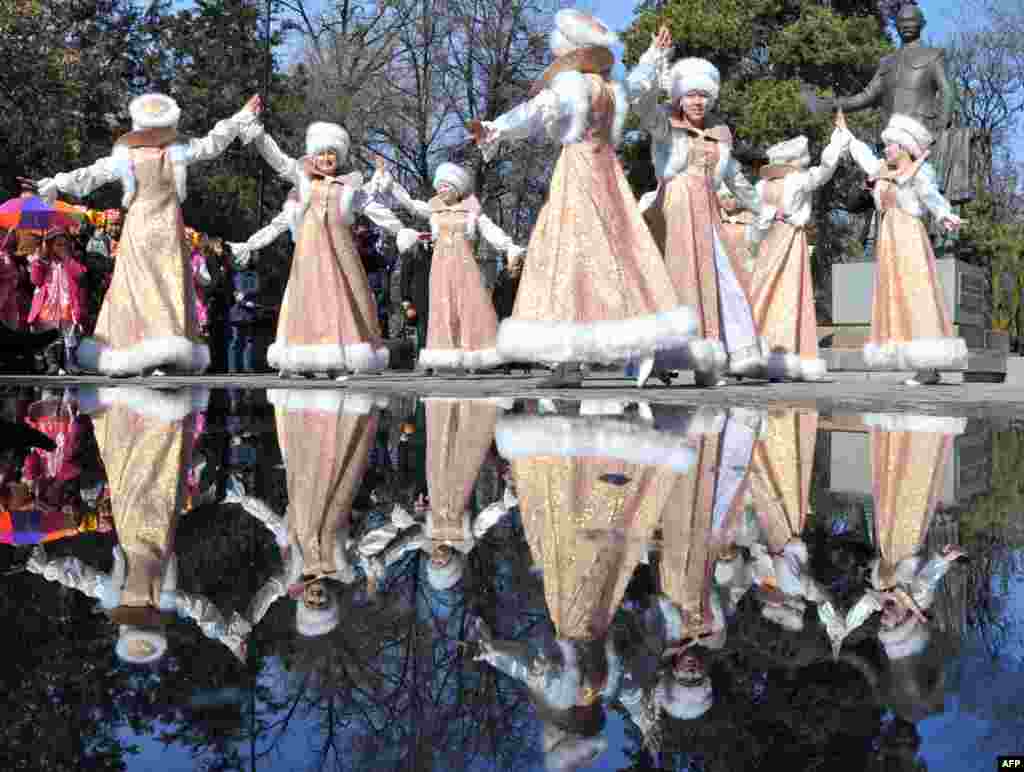 Kyrgyz actors, wearing their traditional costumes, sing and dance during the festivities of Maslenitsa in the Kyrgyzstan's capital Bishkek.