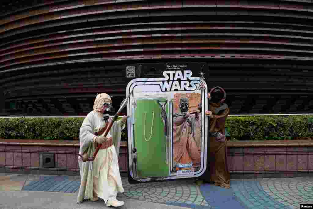 Fans dressed as the characters from "Star Wars" react during Star Wars Day in Taipei, Taiwan.