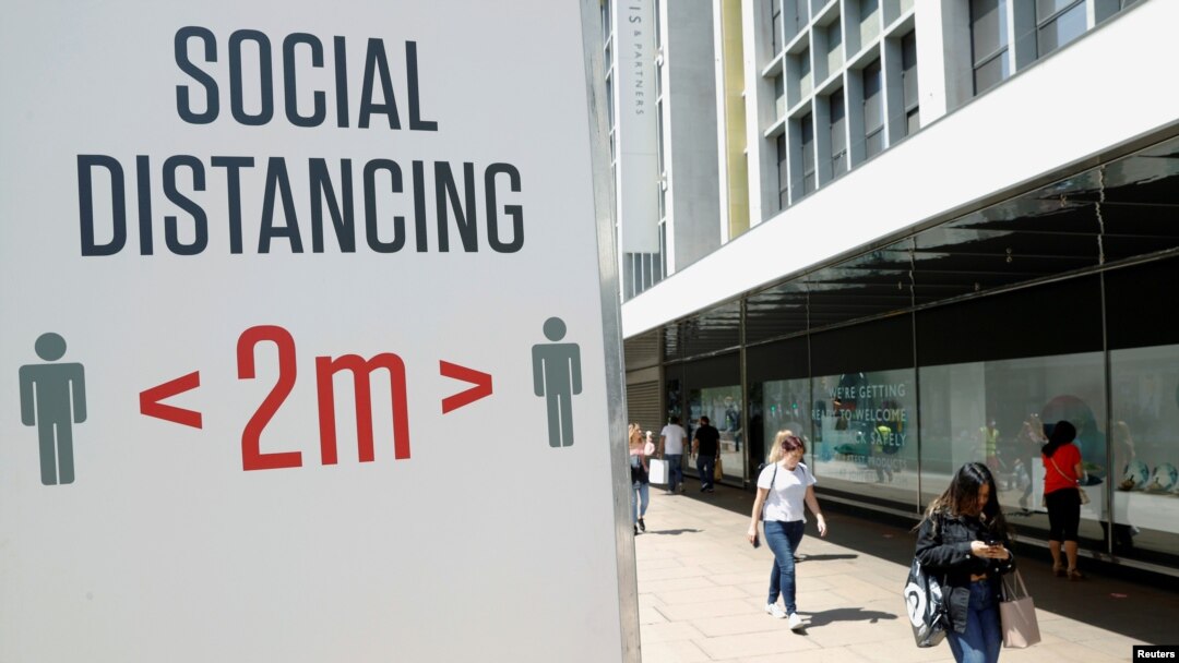 FILE PHOTO: A social distancing sign is seen in Oxford Street, as the outbreak of the coronavirus disease (COVID-19) continues, in London, Britain June 22, 2020. REUTERS/John Sibley/File Photo