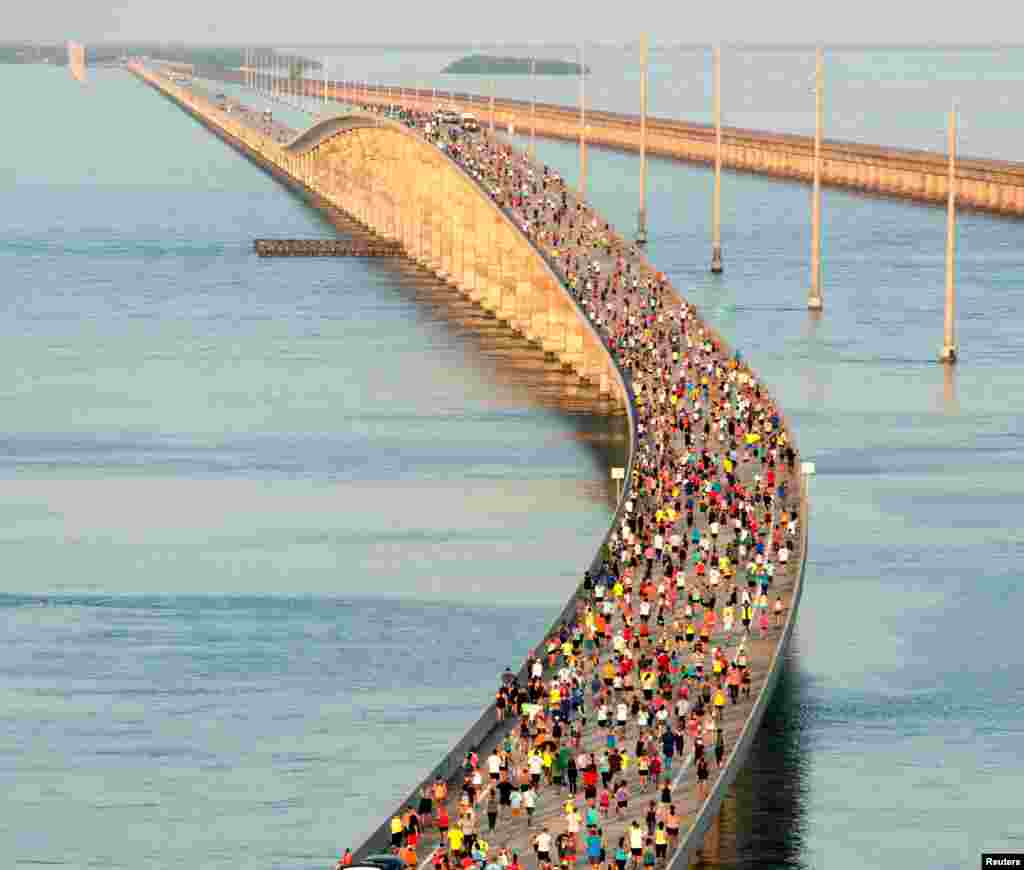 Runners compete in the '7 Mile Bridge Run' over the longest of 42 bridges on the Florida Keys Overseas Highway near Marathon, Florida, April 1, 2017.
