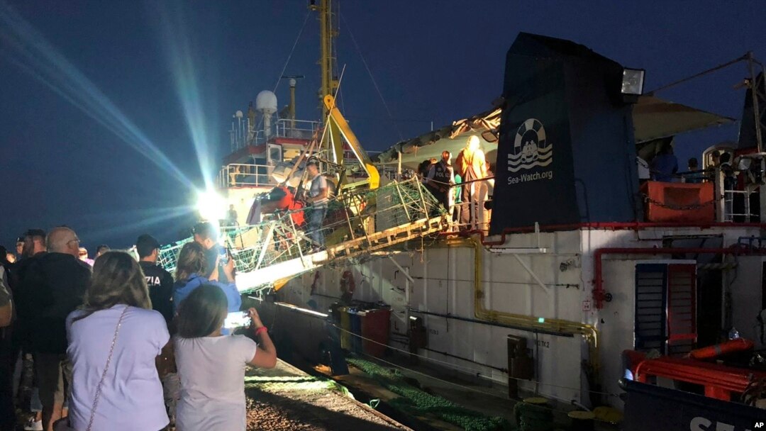 FILE - The Dutch-flagged Sea-Watch 3 ship docks at the Lampedusa harbor, Italy, early Saturday, June 29, 2019. Forty migrants have disembarked on a tiny Italian island after the captain of the German aid ship which rescued them docked without permission. 