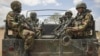 In this photo released by the African Union-UN Information Support Team, Kenyan soldiers serving with the African Union Mission in Somalia at their sector headquarters in the town of Dhobley, Somalia, September 30, 2012. 
