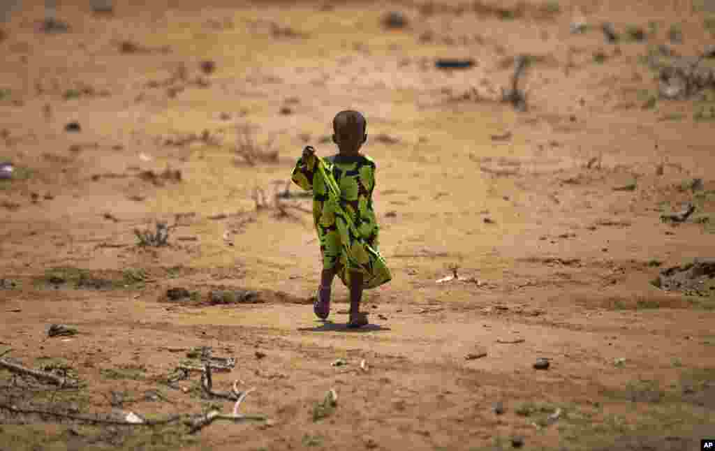 A child walks under the noon sun in the drought-affected village of Bandarero, near Moyale town on the Ethiopian border, in northern Kenya. U.N. humanitarian chief, Stephen O’Brien, toured the village and called on the international community to act to “avert the very worst of the effects of drought and to avert a famine.”