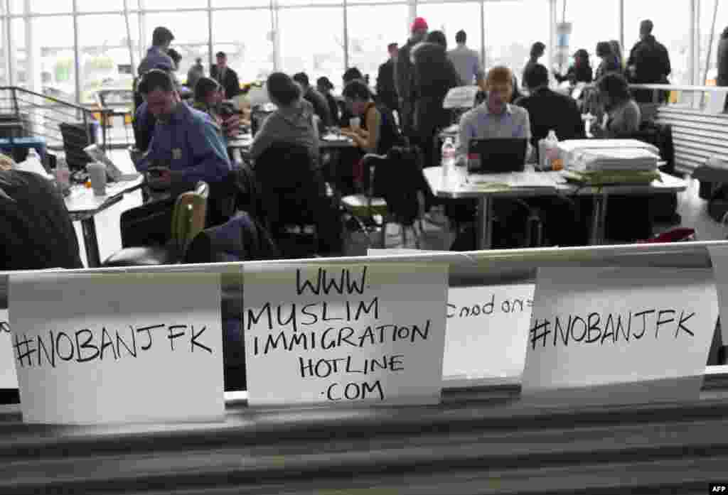 A group of attorneys work inside the arrivals terminal at JFK International Airport in New York. The group is trying to aid arriving passengers who might be affected by U.S. President Donald Trump's immigration order.