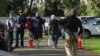 In this image made from video, people bring their guns to exchange for money in Christchurch, New Zealand Saturday, July 13, 2019.