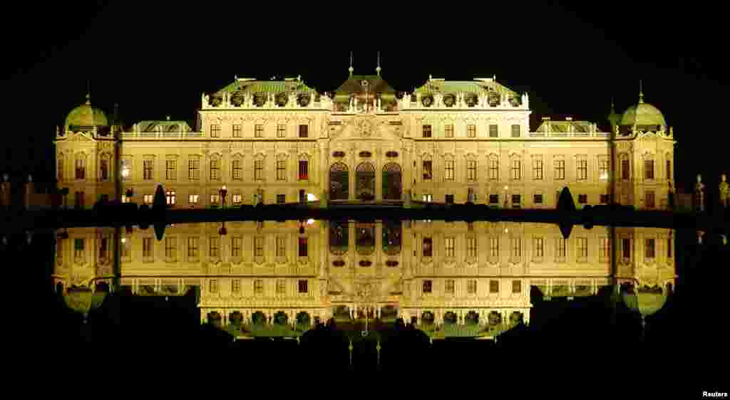 Belvedere palace is reflected in a pond are seen before the lights were switched off for Earth Hour in Vienna, Austria, March 25, 2017.