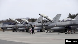 FILE - U.S. Air Force 510th Fighter Squadron F-16 fighters are seen parked on tarmac in Amari air base, in Estonia. Lockheed Martin says talks are being held between the American and Indian governments on its proposal to manufacture F-16 fighter jets in India.