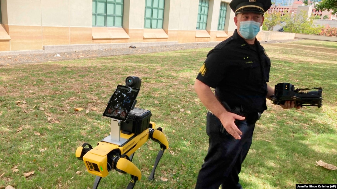 Supervisor Joseph O’Neal of the Honolulu Police Department's community outreach division demonstrates a robotic dog in Honolulu, Friday May 14, 2021. (AP Photo/Jennifer Sinco Kelleher)