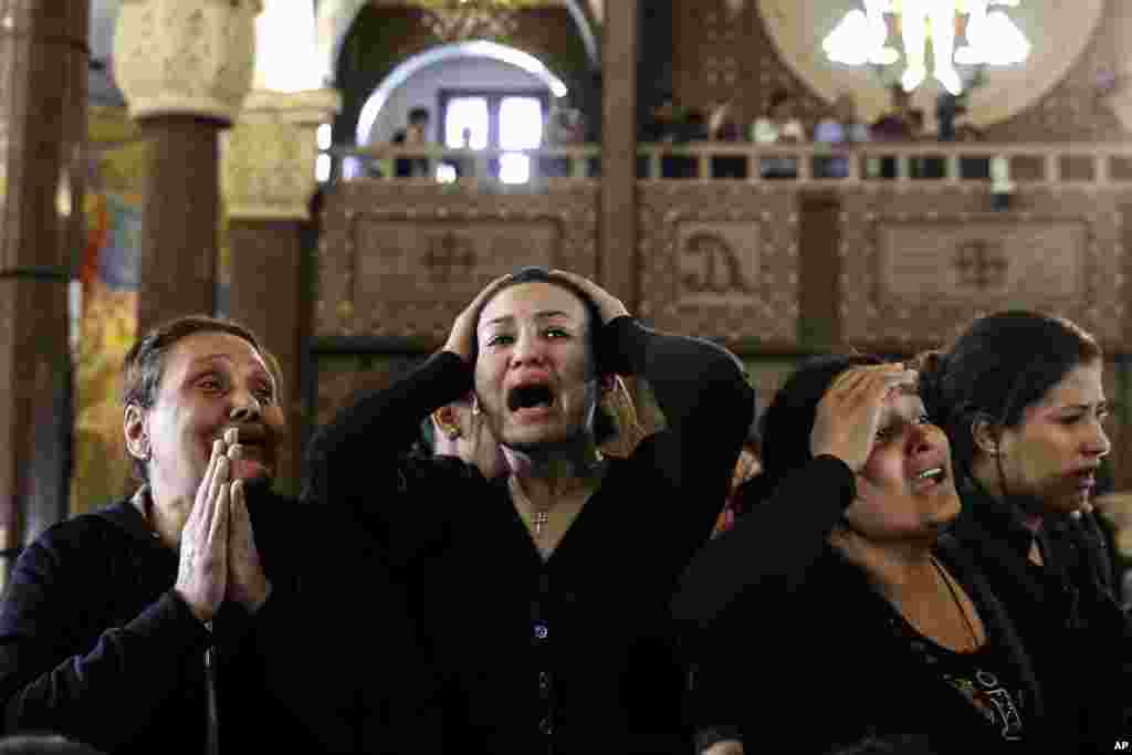 Women cry at the Mar Amina church during the funeral for those killed in a Palm Sunday church attack in Alexandria, Egypt.