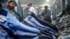 FILE - Customers browse secondhand clothes in a shop at a market in New Delhi, Sept. 28, 2024. 