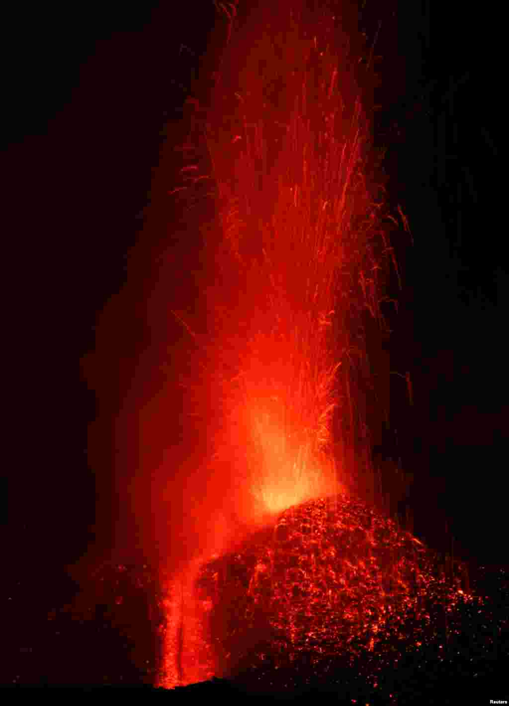 Italy's Mount Etna, Europe's tallest and most active volcano, spews lava as it erupts on the southern island of Sicily, Italy, Feb. 27, 2017.