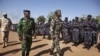 Ivory Coast army chief-of-staff Soumaila Bakayoko (L) and Malian army chief-of-staff Ibrahima Dahirou Dembele (C) inspect Malian troops at an air base in Bamako, Mali, January 16, 2013. 