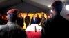 French President Francois Hollande (C) pays tribute near a flag-draped coffin bearing one of two French soldiers who was killed overnight, in Bangui, Dec. 10, 2013. 