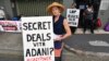 FILE - Anti-Adani coal mine protestor Rae Sheridan is seen outside the LNP (Liberal National Party) headquarters in Brisbane, April 11, 2019. The protestors are trying to stop the building of Adani's Carmichael coal mine. 