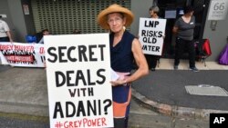 FILE - Anti-Adani coal mine protestor Rae Sheridan is seen outside the LNP (Liberal National Party) headquarters in Brisbane, April 11, 2019. The protestors are trying to stop the building of Adani's Carmichael coal mine. 