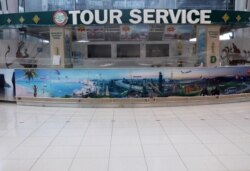 FILE - A closed tourist service counter is seen at the arrivals hall of Suvarnabhumi Airport during the coronavirus pandemic, in Bangkok, Thailand, Oct. 12, 2020.