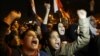 Protesters chant slogans during a demonstration in front of the presidential palace in Cairo, Egypt, Sunday, Dec. 9, 2012.