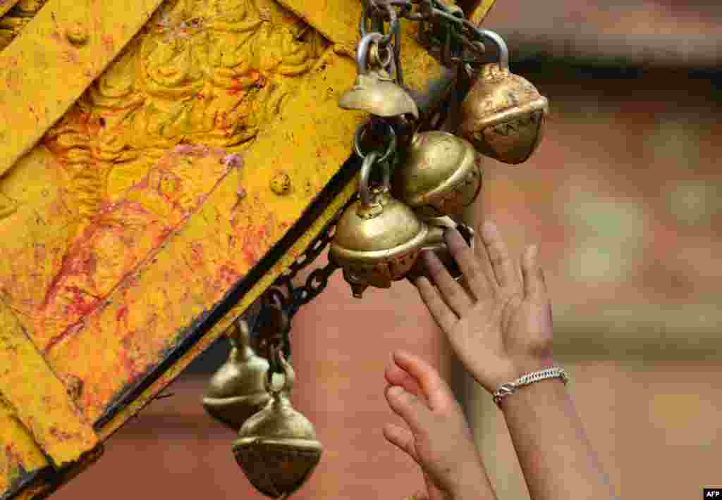 Nepalese revelers ring bells on a wooden chariot during celebrations for the Nepalese New Year or "Bisket Jatra" in Bhaktapur, some 12 kms east of Kathmandu. The festival which began April 10, is celebrated for nine days by the ethnic Newar community in Bhaktapur.