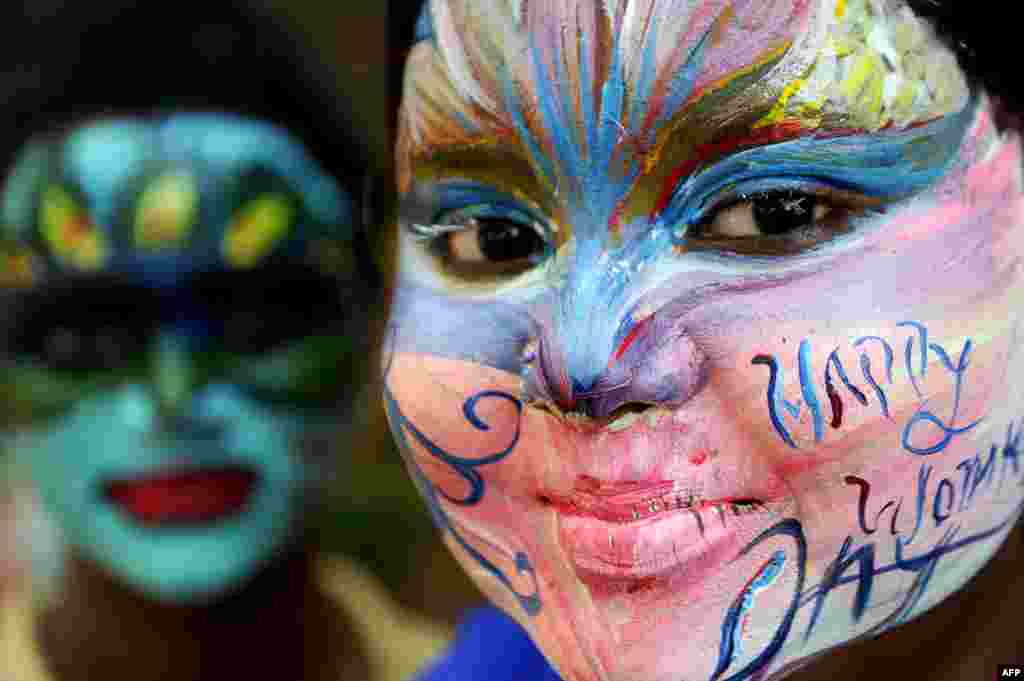Indian students pose with their faces painted at a college in Chennai ahead of International Women's Day.