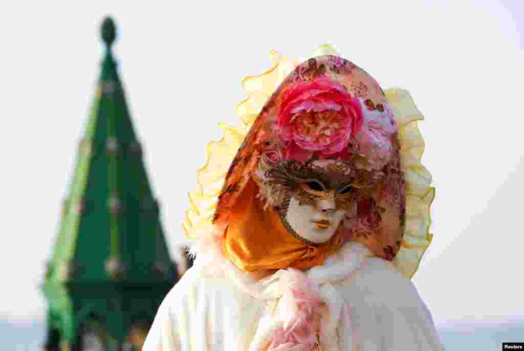 A reveler poses in Saint Mark's Square during the Carnival in Venice, Italy, Feb. 18, 2017.